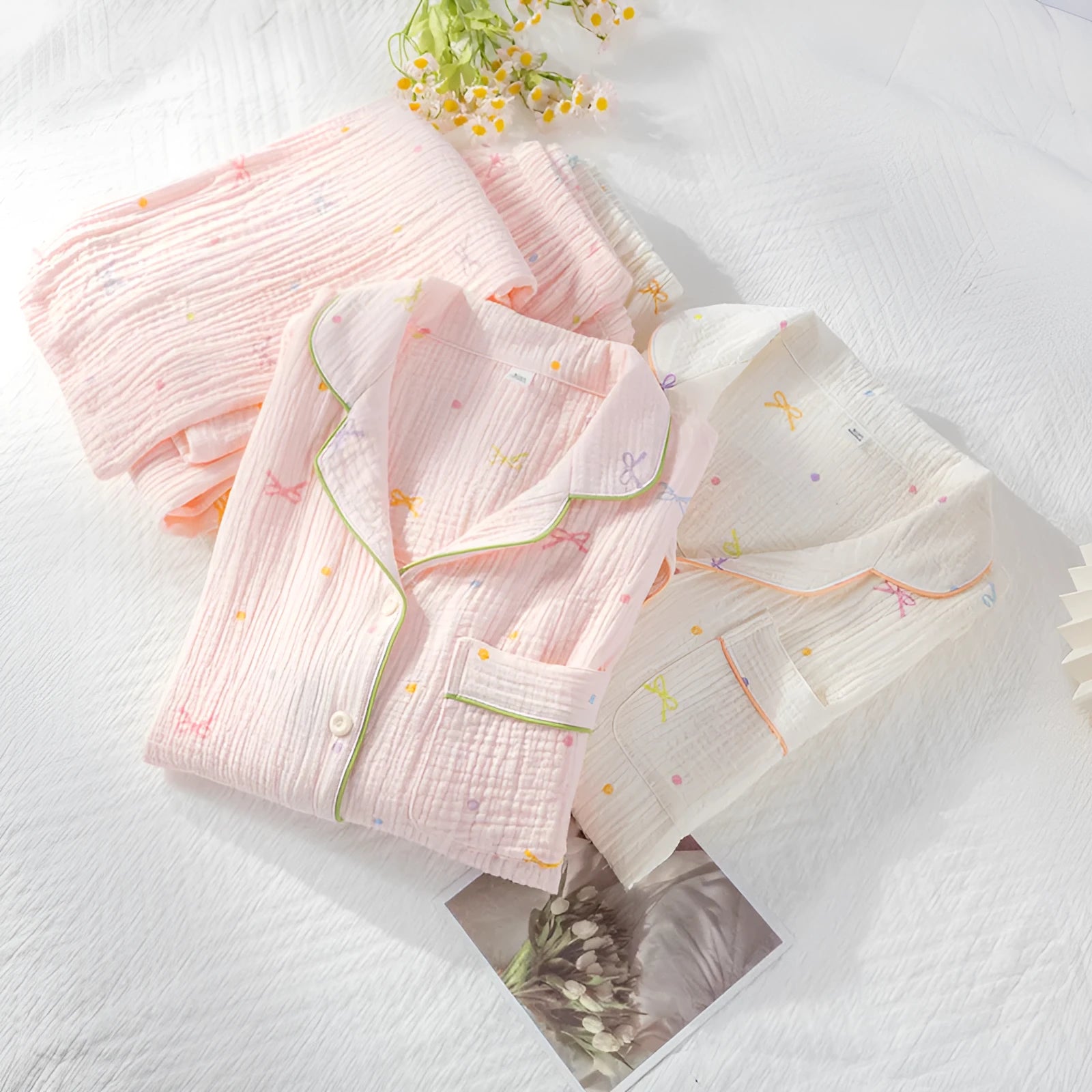 Beige and pink women's long-sleeved cotton pajama set with trousers on hanger.