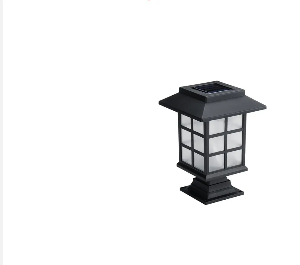 Black solar-powered outdoor LED lawn light with window-style openings, shown in a garden setting.