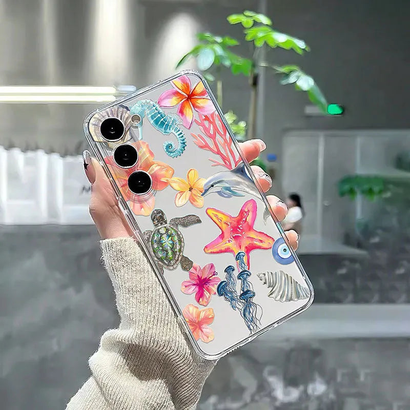Transparent TPU iPhone case with painted dolphin and turtle design on a phone.