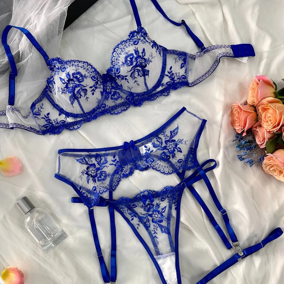 Women's sapphire blue see-through embroidery underwear set with cutouts, includes top, t-pants, and garters.