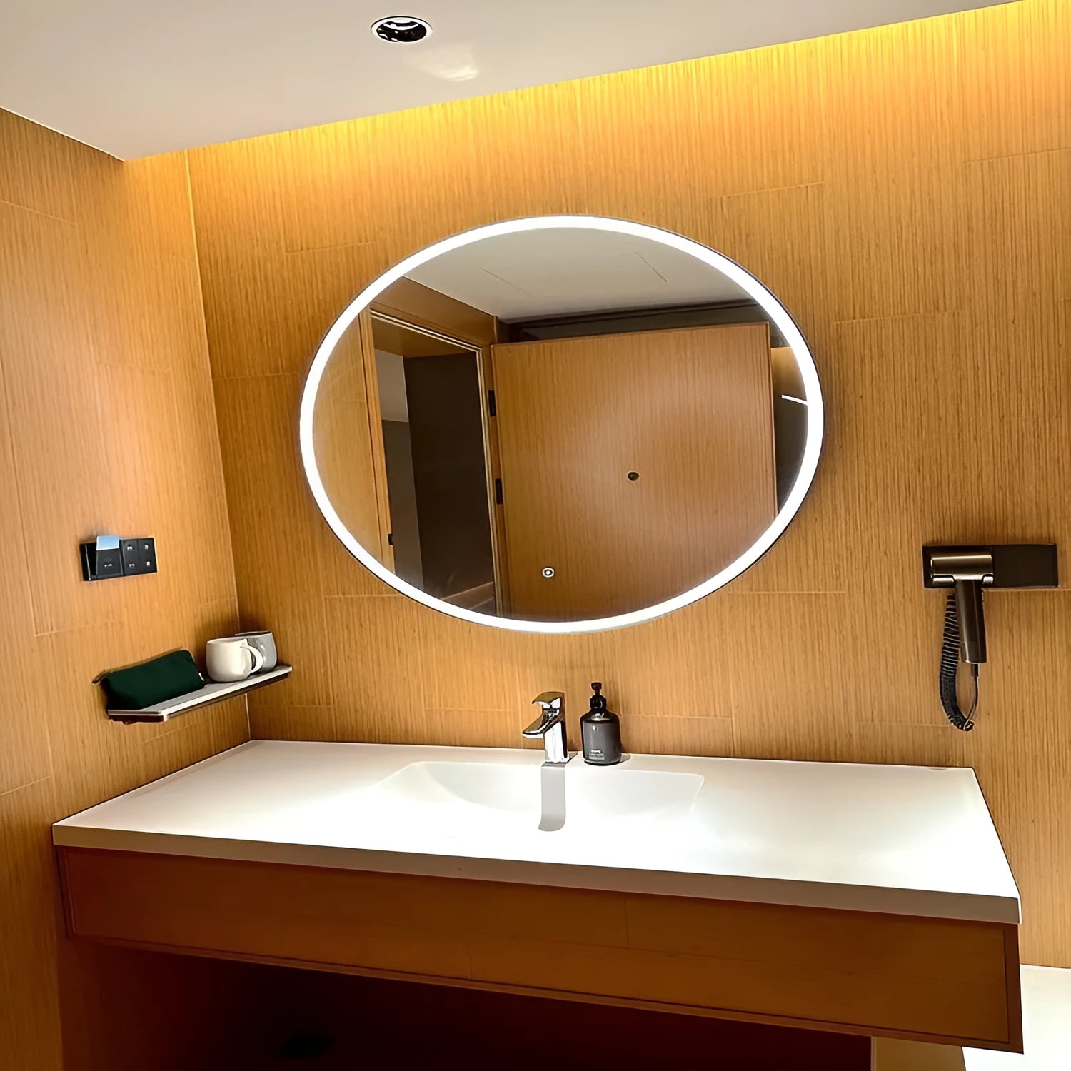 Round smart bathroom mirror with black aluminium frame and LED lighting