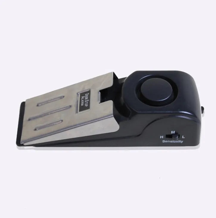 Black wedge-shaped door alarm with stainless steel cover and sensitivity controls
