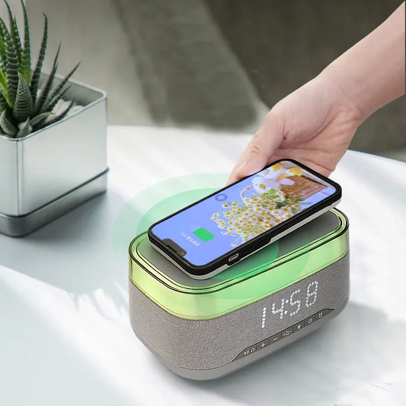 White multifunctional alarm clock with Bluetooth speaker and wireless charging pad for mobile phones