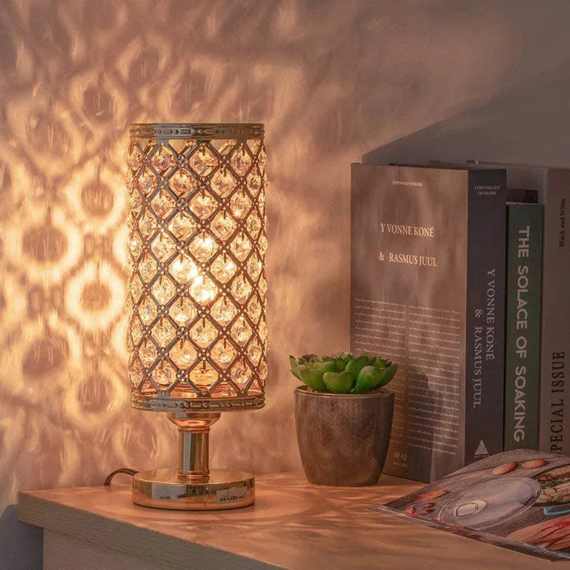 Modern crystal table lamp with metal base and hollow-carved shade in gold finish