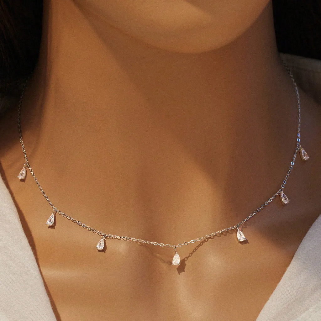 Women's silver necklace with drop-shaped zircon pendant on an adjustable O-chain, shown in silver finish.