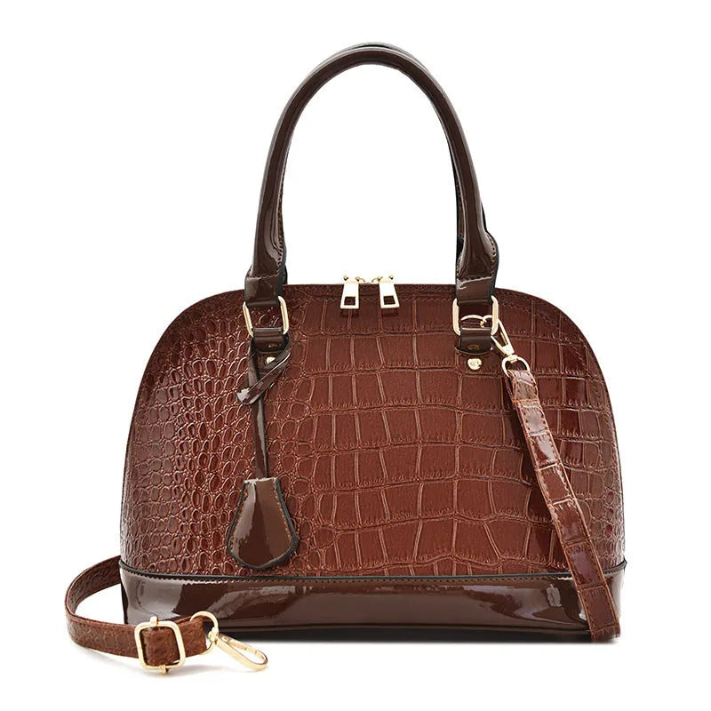 Shiny black PU crossbody shoulder bag with a structured shell shape.
