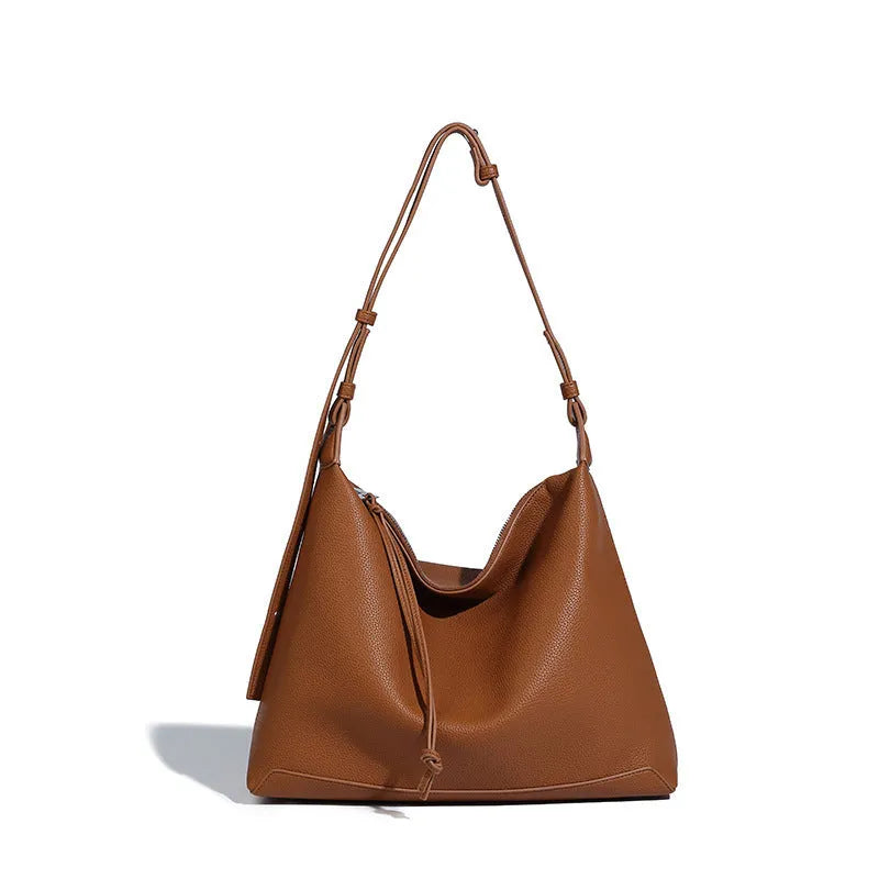 Large soft PU messenger bag in caramel colour showing shoulder strap and dimensions