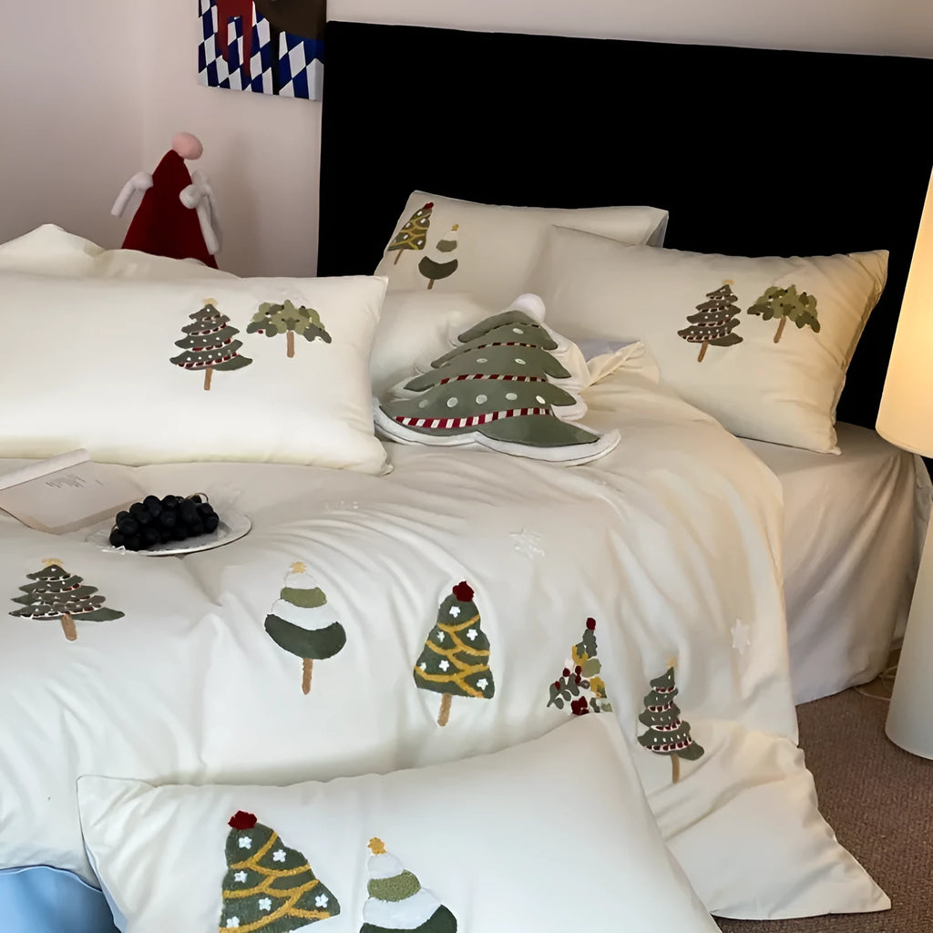 Cream blue cotton duvet cover and pillowcases with embroidered green Christmas tree and flower design.
