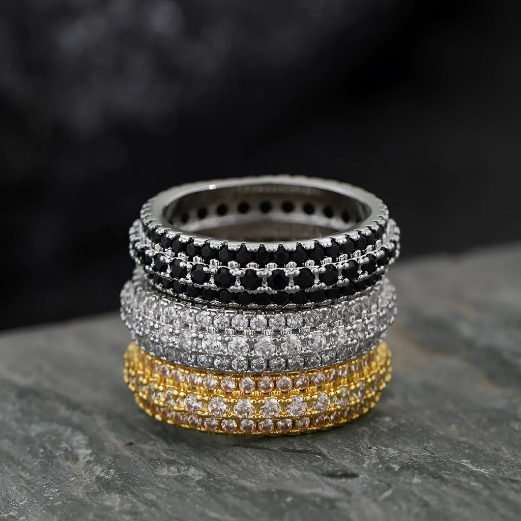 Geometric triangle zircon inlay ring in white gold, yellow gold, and white and black finishes on a copper band.