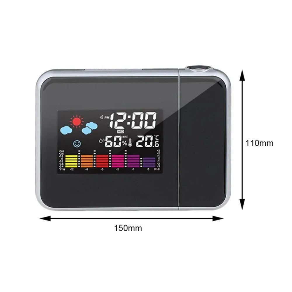 Black digital projection alarm clock on a surface, showing its compact plastic design.