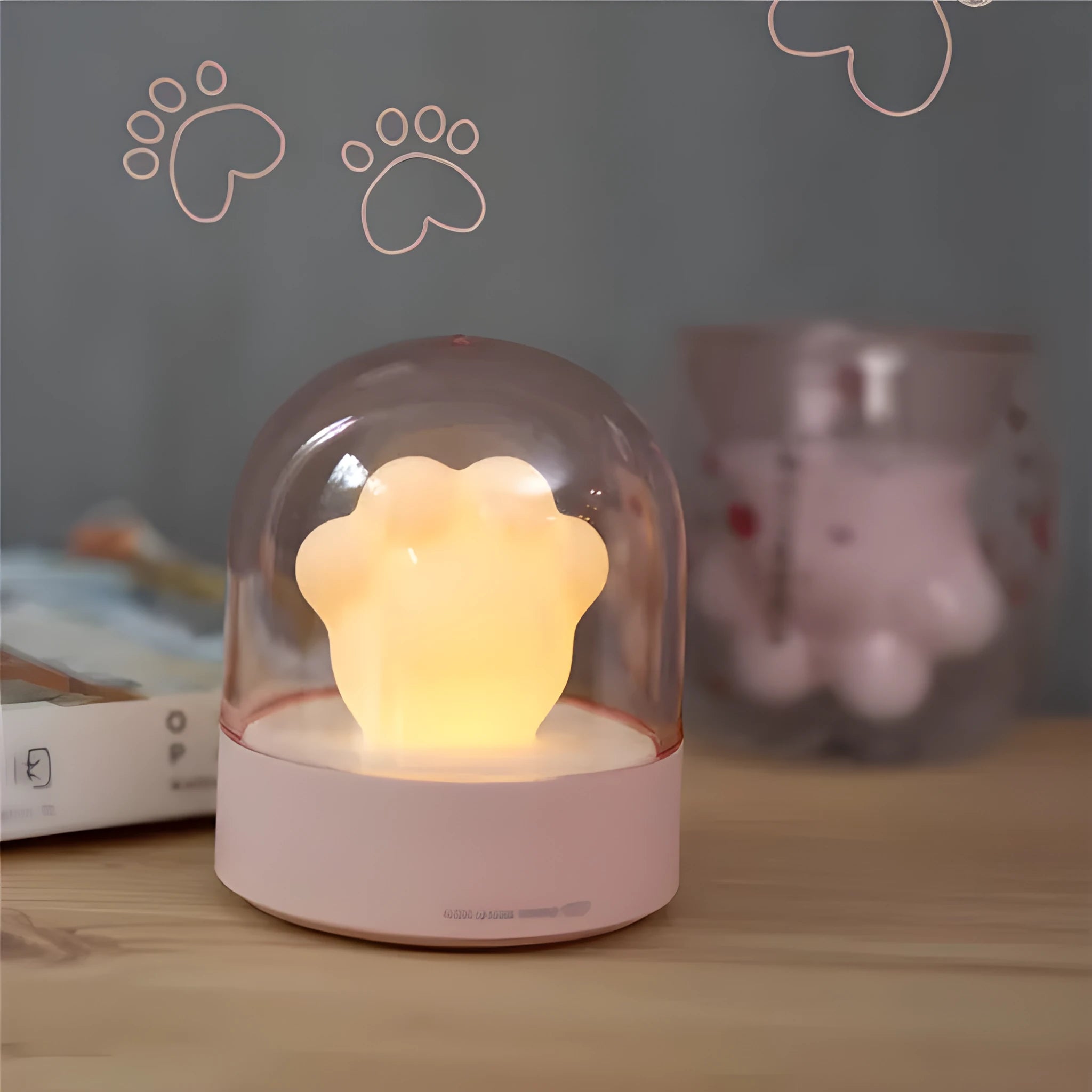 Grey cat paw shaped USB rechargeable night light with music box feature on wooden desk