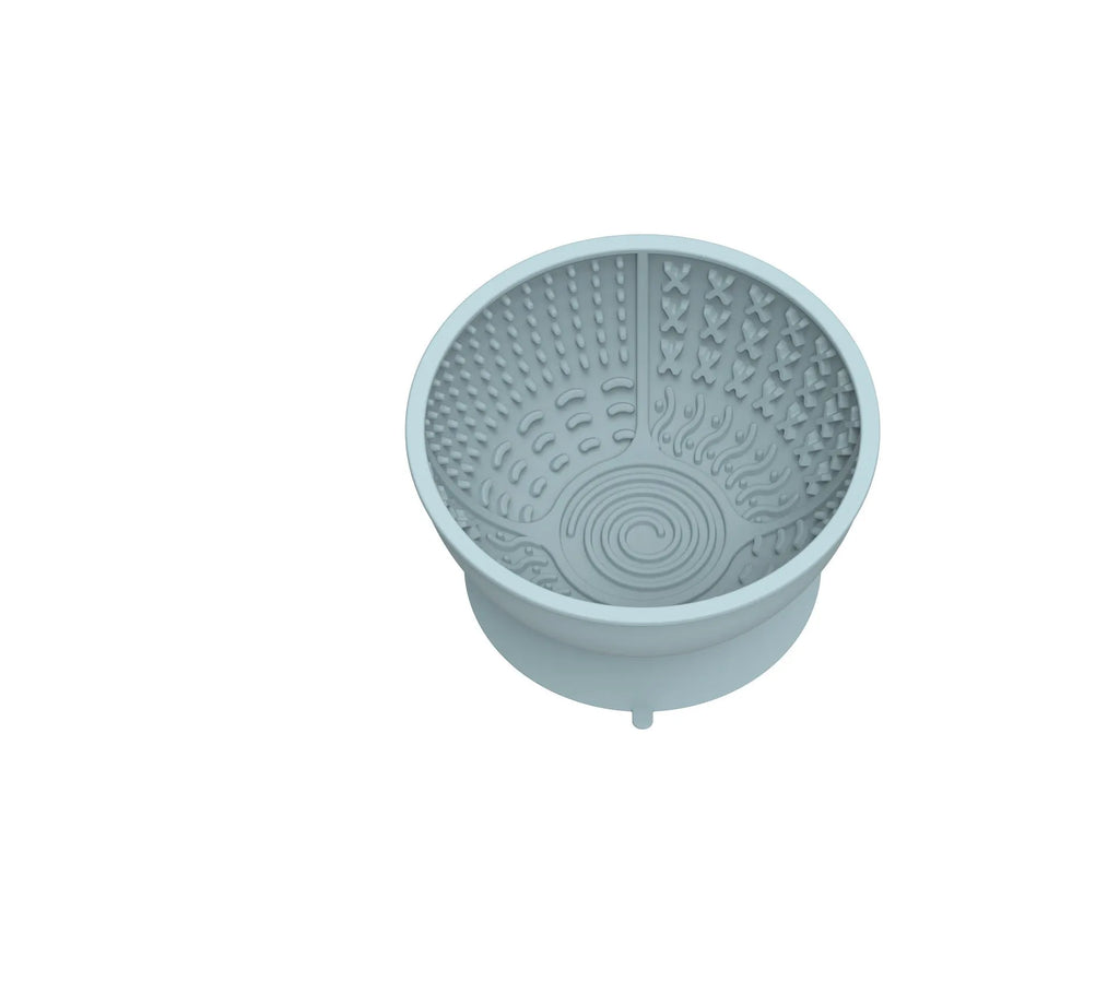 Cyan silicone dog bowl with textured slow-feeding surface and suction cup base.