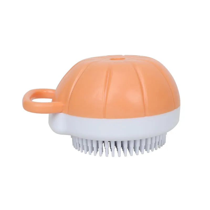 Orange dog bath brush with shampoo dispenser and soft TPR bristles for pet grooming