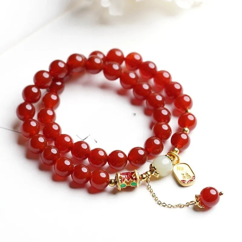 Women's red agate and Hetian jade bracelet with gold plating showing single circle, double circle, and happy ankang styles.