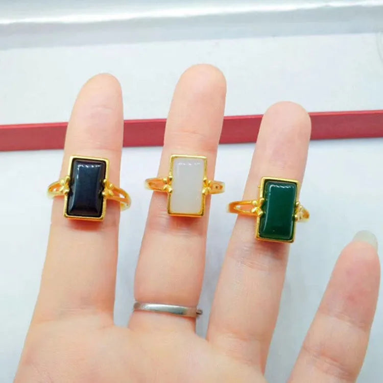 Adjustable brass gold-plated ring with a green gemstone set in a national style design.