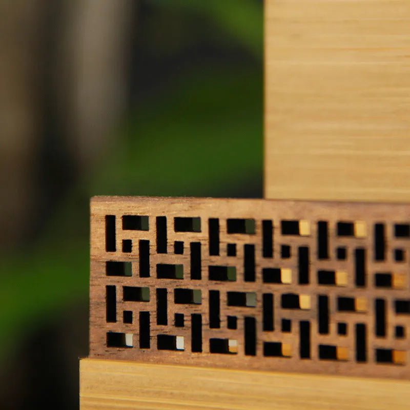 Geometric bamboo and black walnut business card holder on a desk
