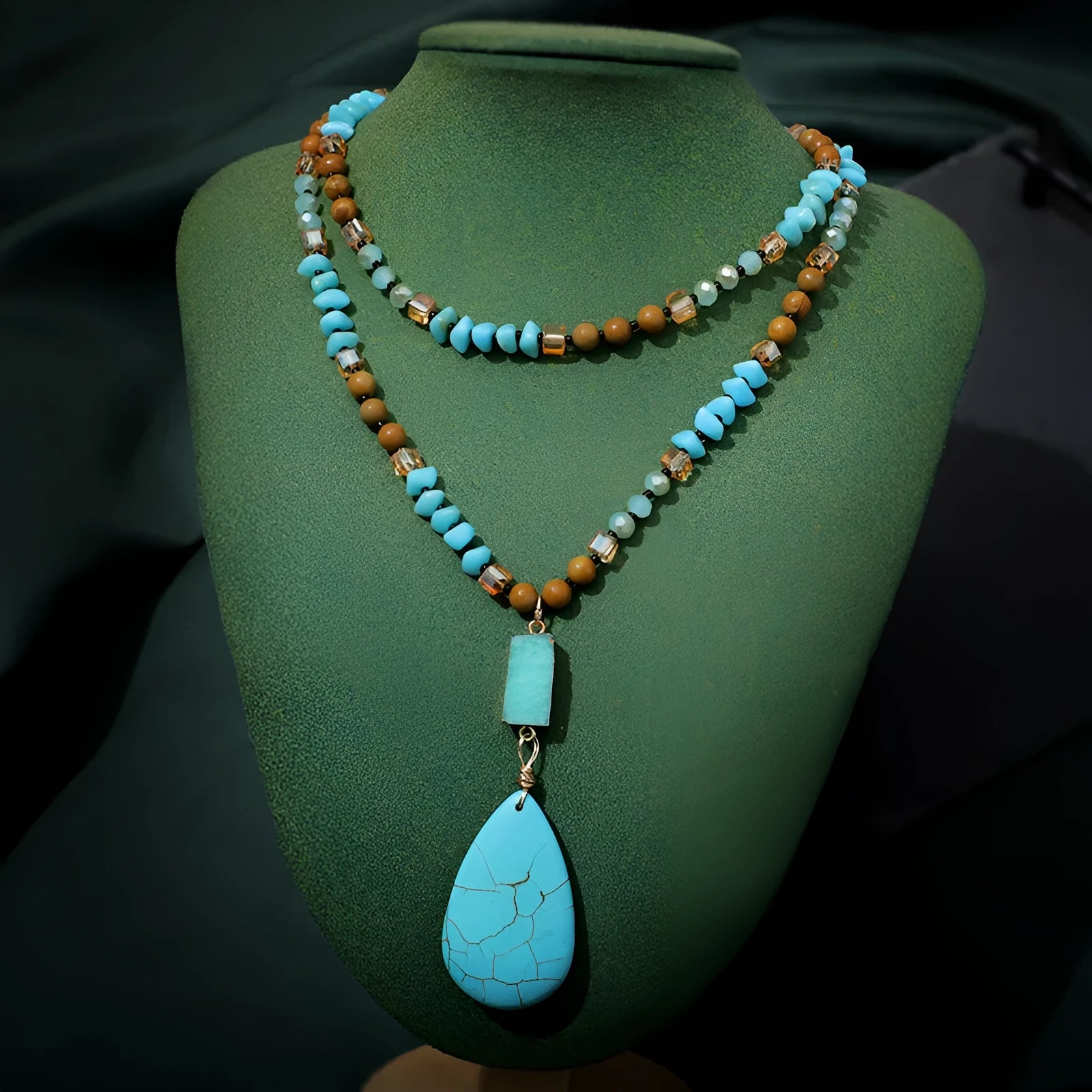 Turquoise water drop shaped pendant necklace with mixed gem inlaid detailing on ball bead chain