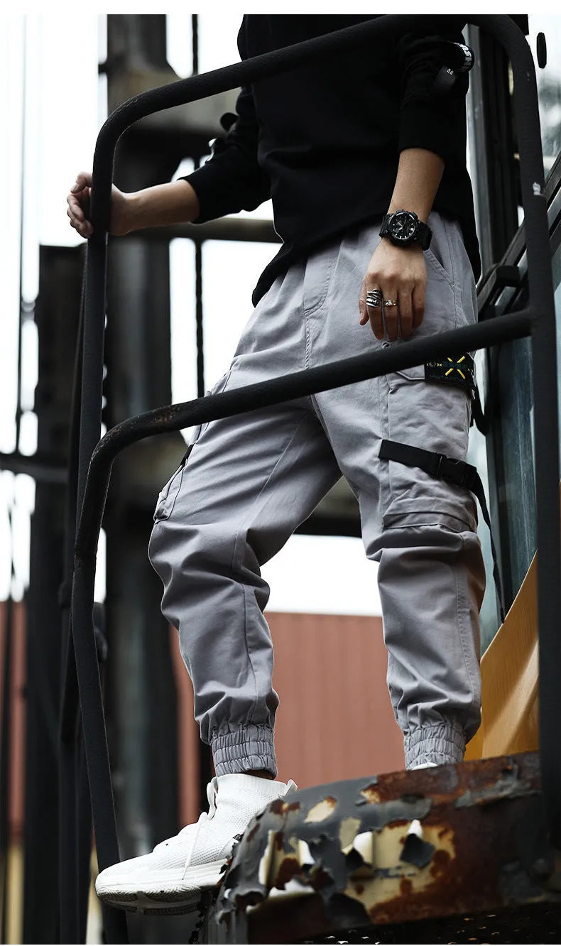 Men's casual cotton cargo pants in black with multiple pockets, available in Asian sizes S to XL