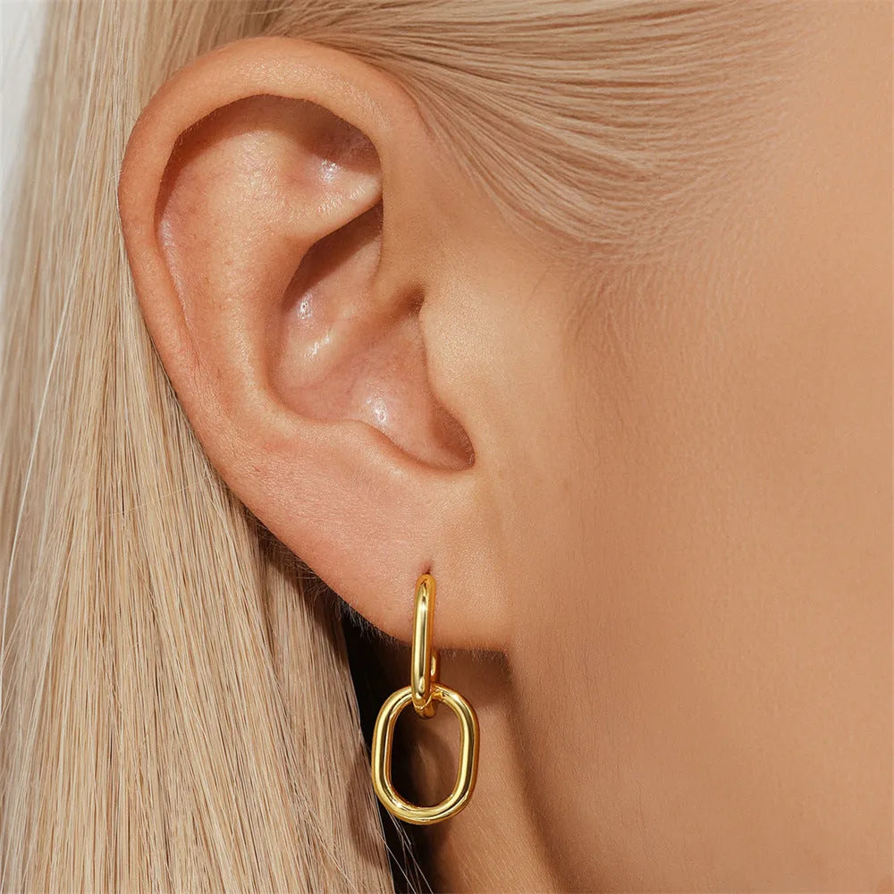 Geometric brass diamond earclip earrings with round elements in golden electroplated finish