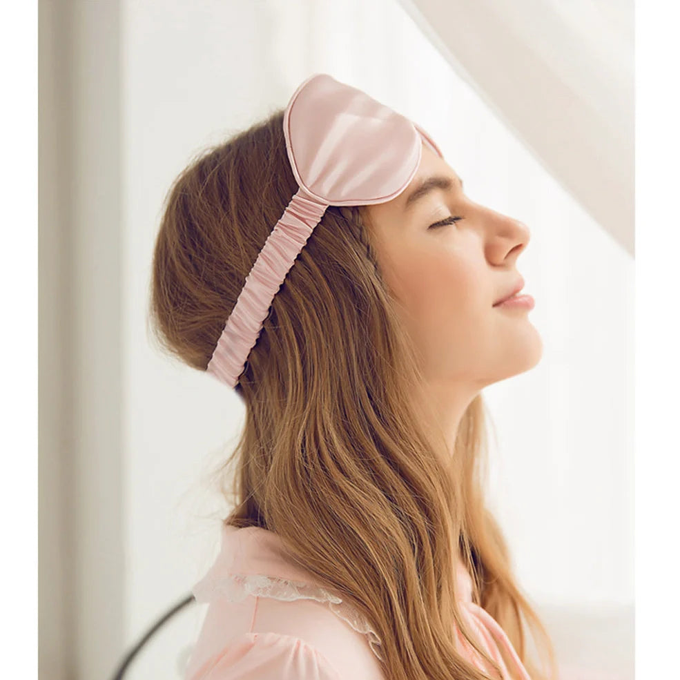 Silk double-sided eye mask in peacock blue and silver with adjustable strap, showing contoured nasal bridge design