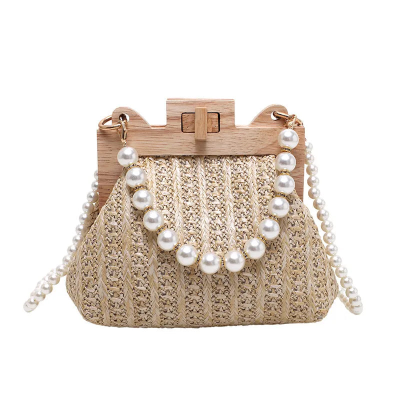 Women's woven straw shoulder bag with pearl chain detail, shown in beige, featuring internal organiser pockets.