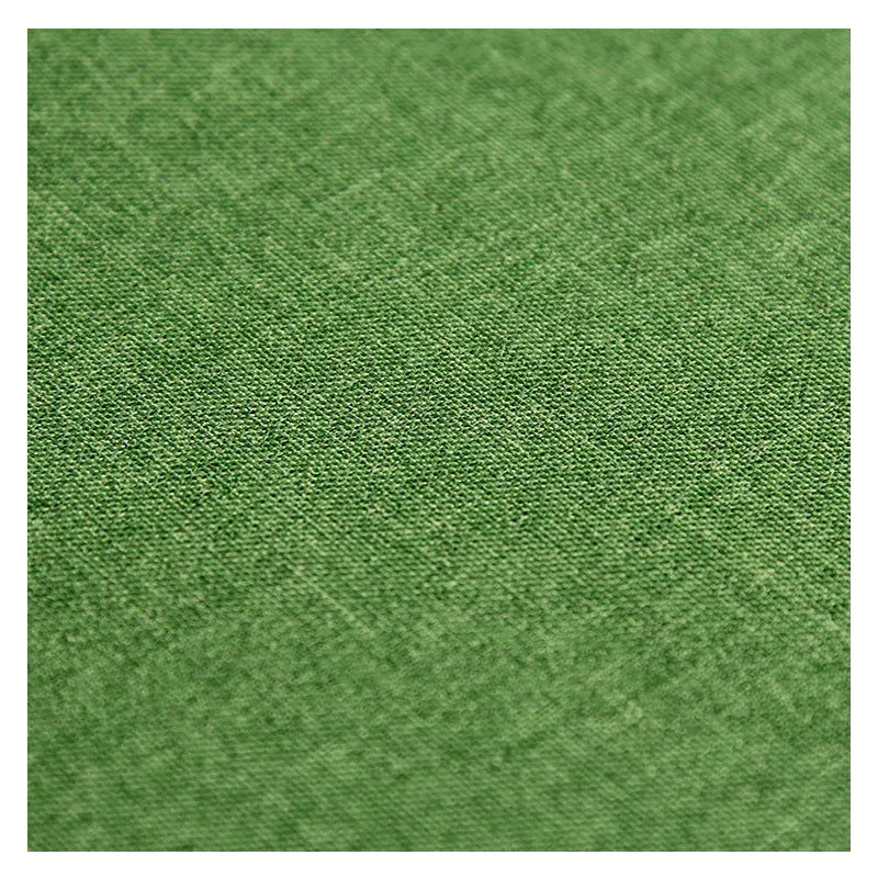 A black, blue, and green polyester ant cloth laid flat, used as a protective cover on a piece of luggage.
