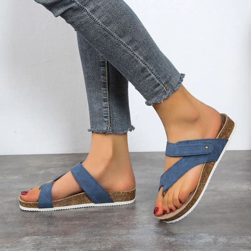 Flat toe ring flip-flops with thick foam sole in blue colour on a white background.