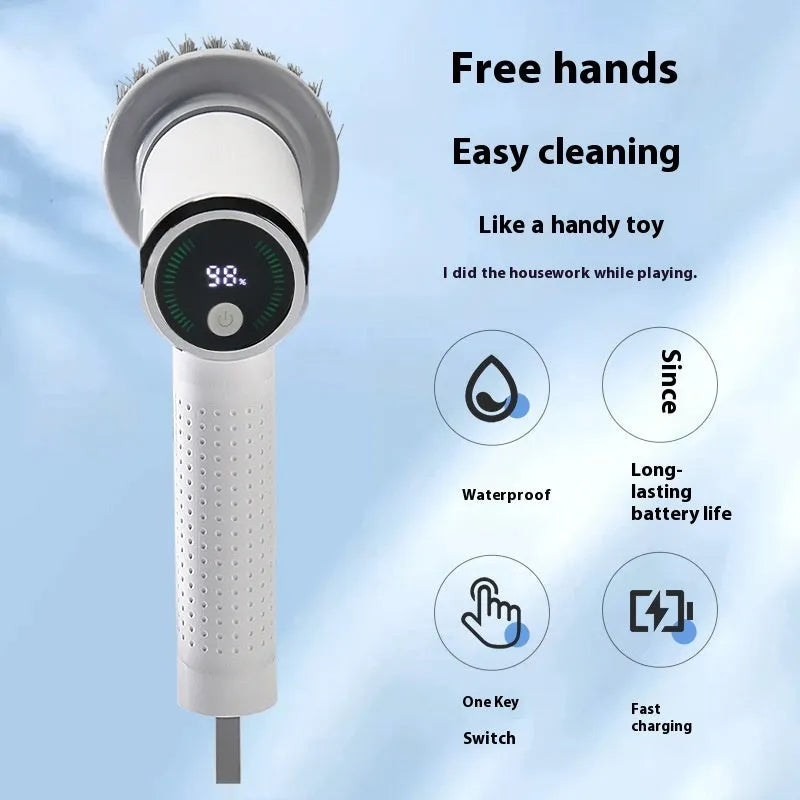 White cordless electric cleaning brush with interchangeable brush heads on a kitchen counter.