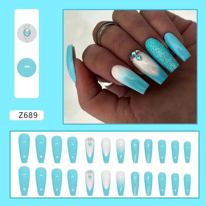 Solid colour artificial nails with smart blue diamond accents and ballet-length cut