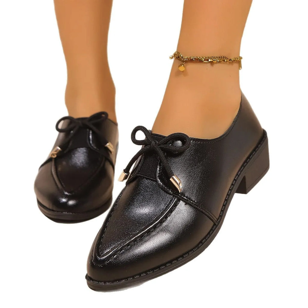 Women's pointed toe PU leather shoes with a bow detail on the upper.