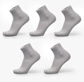 A pair of men's bamboo fibre ankle socks with a small square pattern, shown in one of the five available colours.