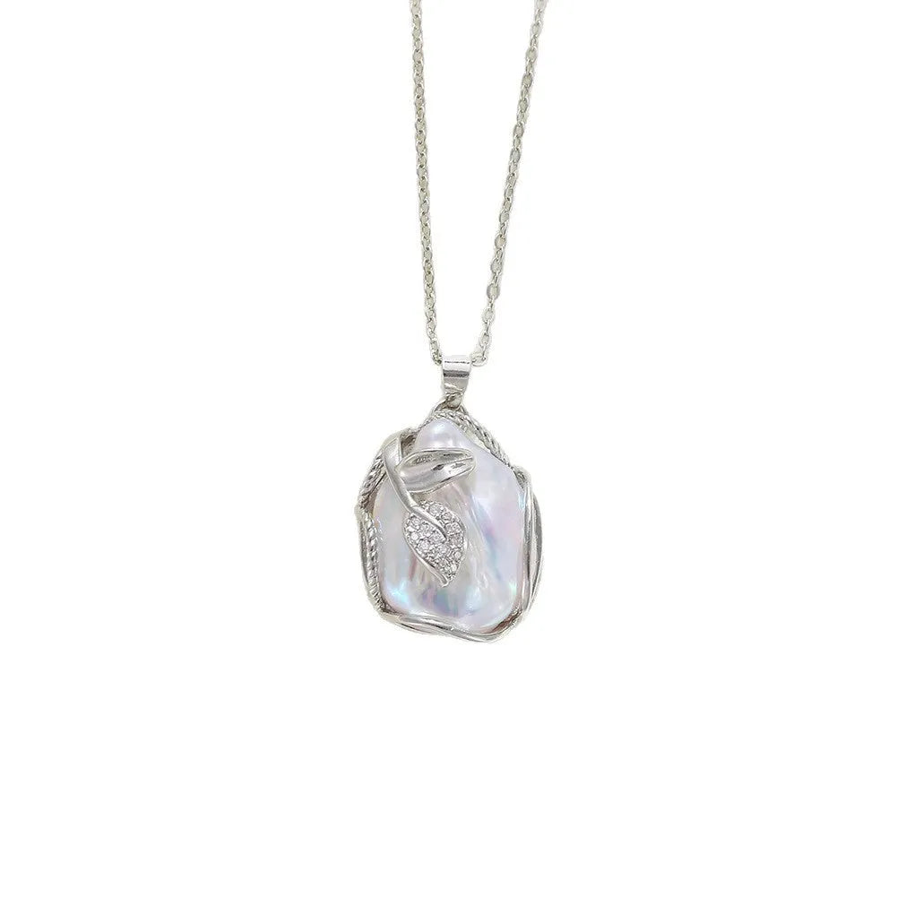 Baroque pendant freshwater pearl necklace clavicle chain with flower leaf motif in Golden Leaves colour, on display