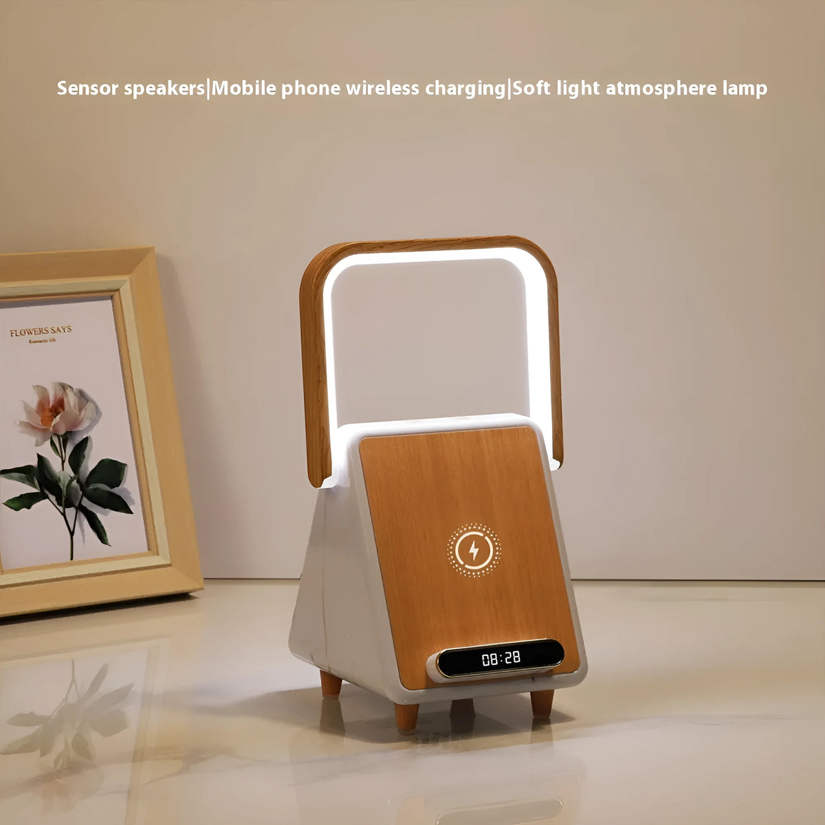Wireless charging induction Bluetooth speaker small night lamp in Platinum Jazz finish with USB cable on a wooden desk