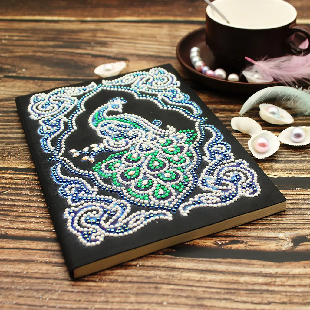 Black A5 diamond painting notebook with peacock design using shaped and bright drills.