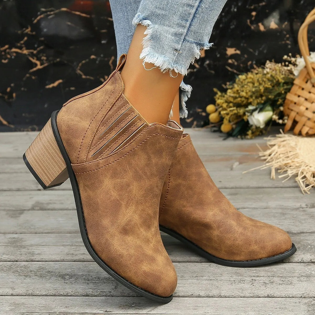 Black women's ankle boots with a pointed toe and thick square heel on a rubber sole.