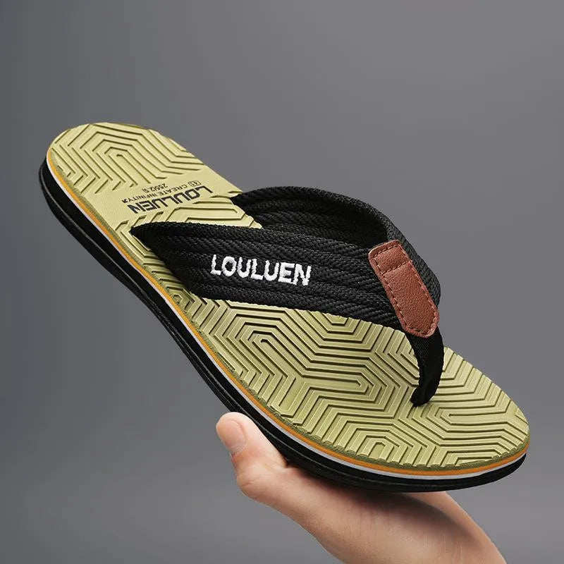 Men's black flip flops with textured non-slip PVC sole and EVA upper on a sandy beach.