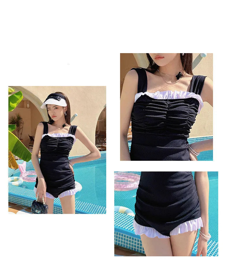 Women's black one-piece swimsuit with suspender straps, polyester fabric, solid colour design