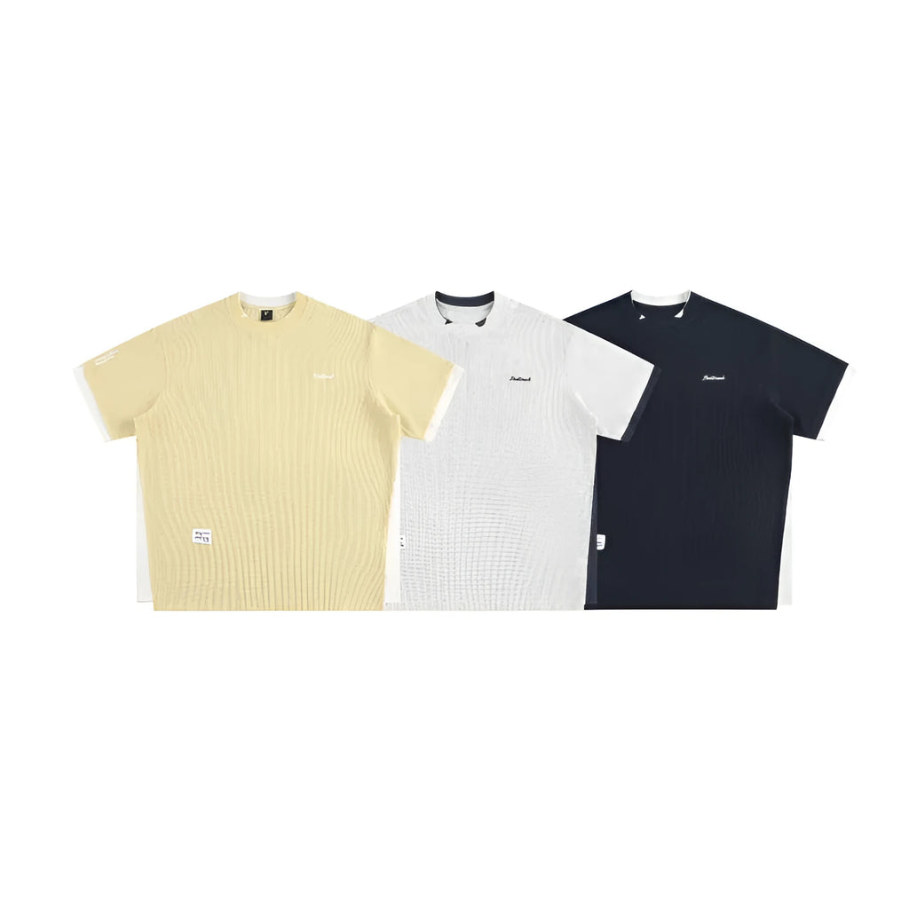 Loose waffle-knit short-sleeved t-shirt with retro alphabet embroidery on the front, shown in navy blue.