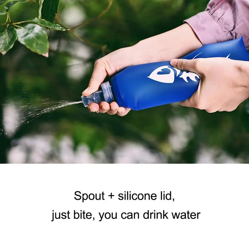 Blue sports soft water bottle with silicone lid on outdoor ground
