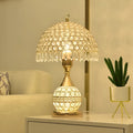 Gold crystal desk lamp with iron art base on wooden table