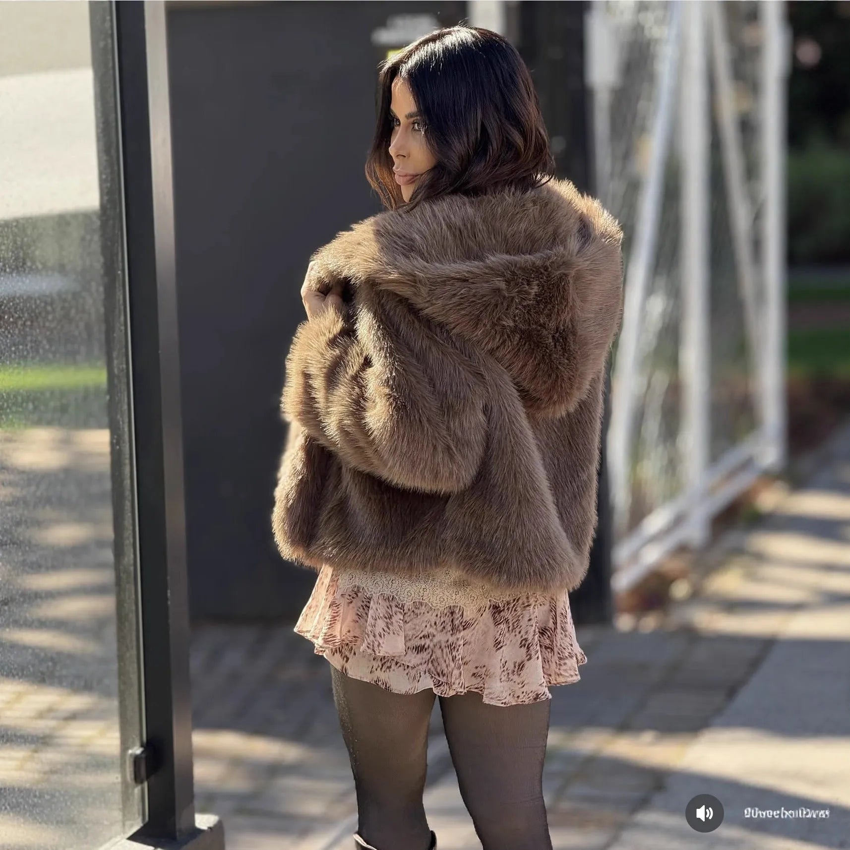 Women's brown loose hooded jacket with fox fur trim on a white background, front view