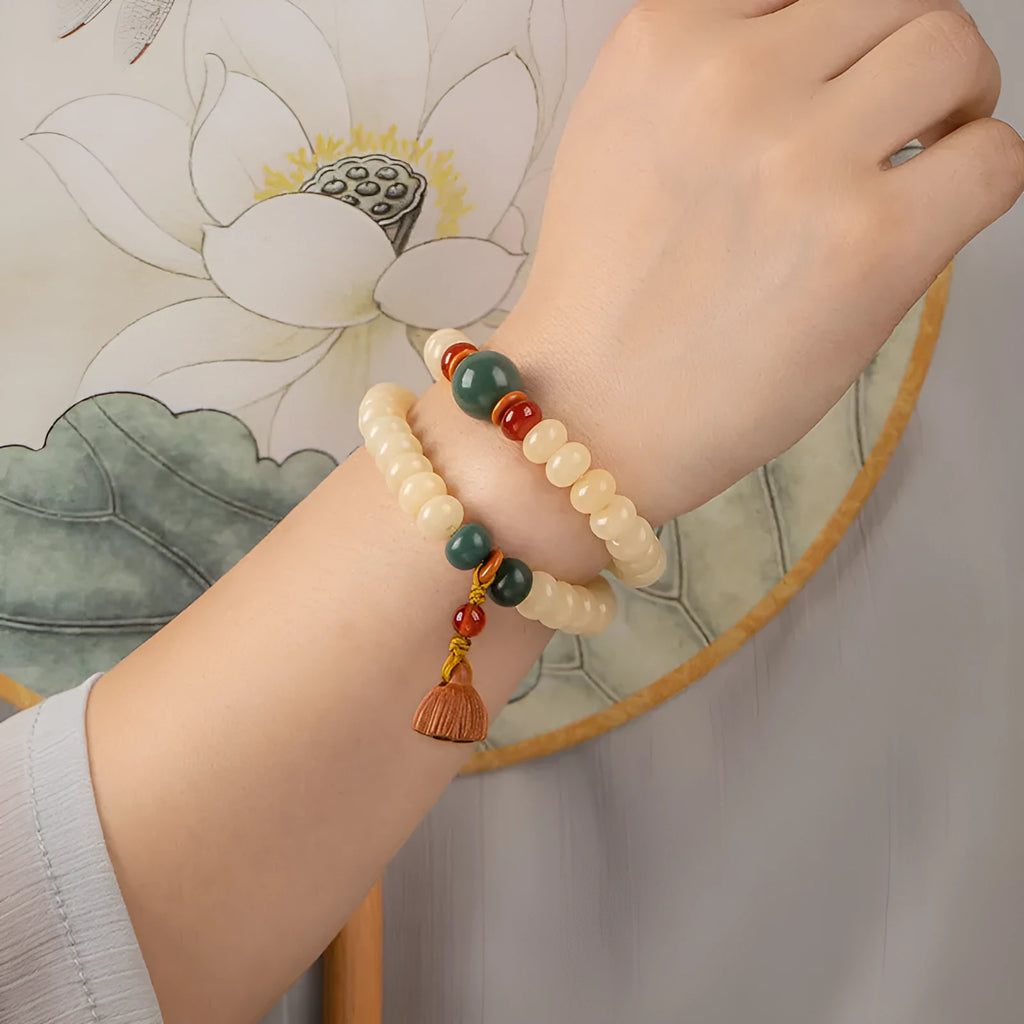 Wooden Bodhi root bracelet with flat round 6x9mm beads in milk butter colour