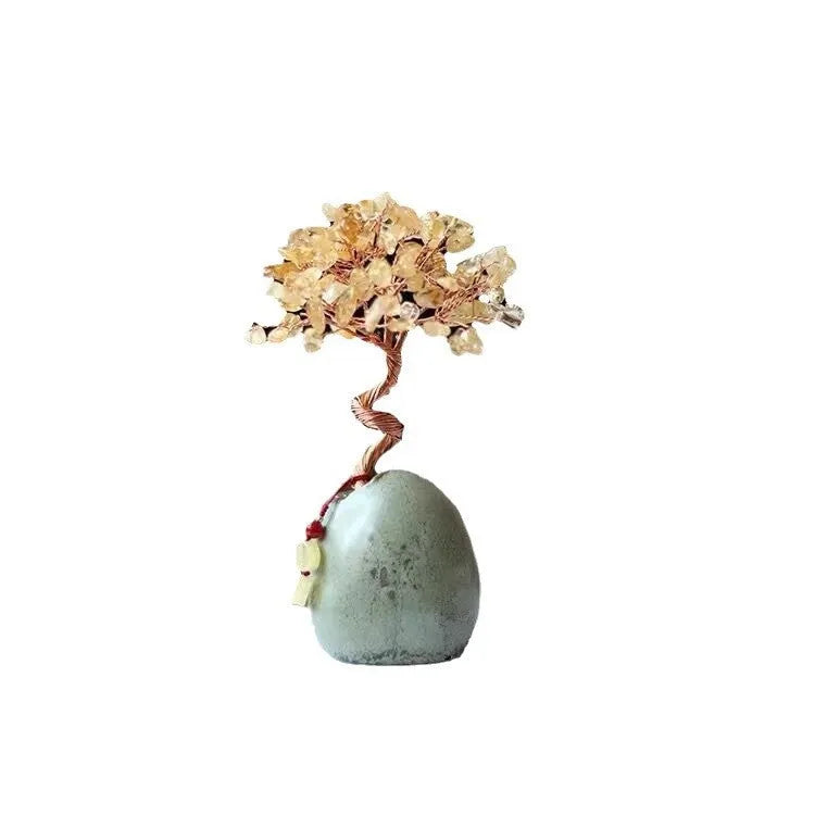 Natural citrine crystal Pachira macrocarpa ornament in warm yellow on a white background