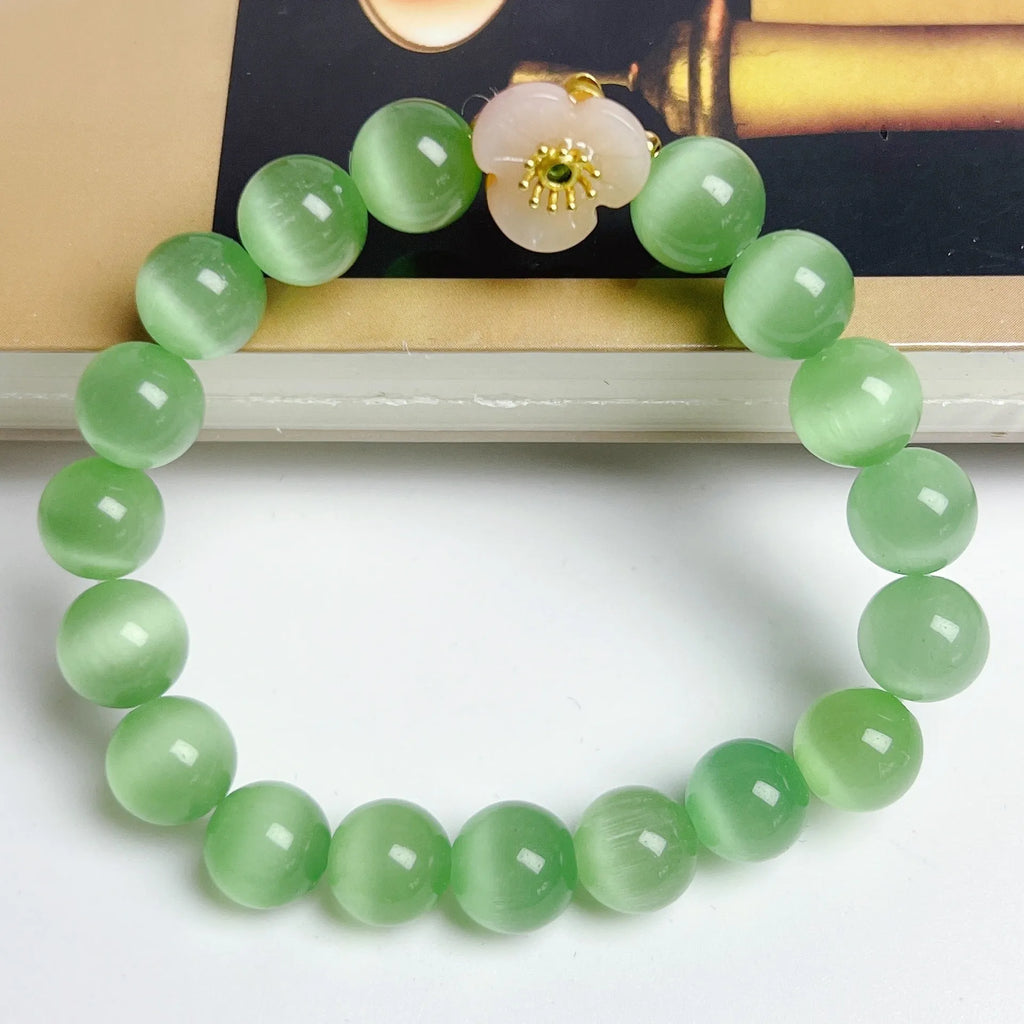 Handmade glass beaded bracelet with floral design in yellow, pink, white, or green colour options.