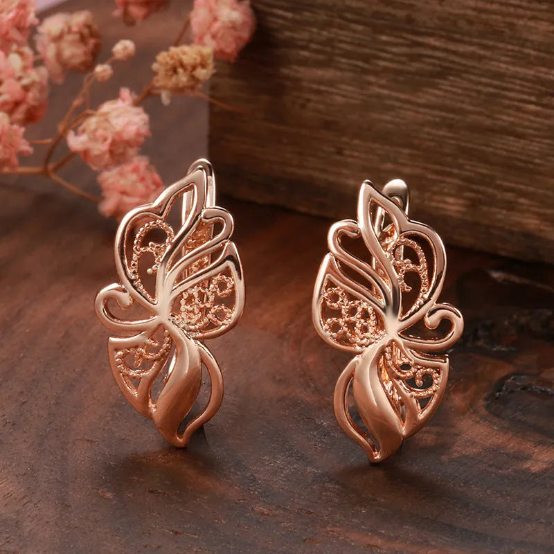 Women's rose gold earrings with hollow carved geometric design and rhinestone accents