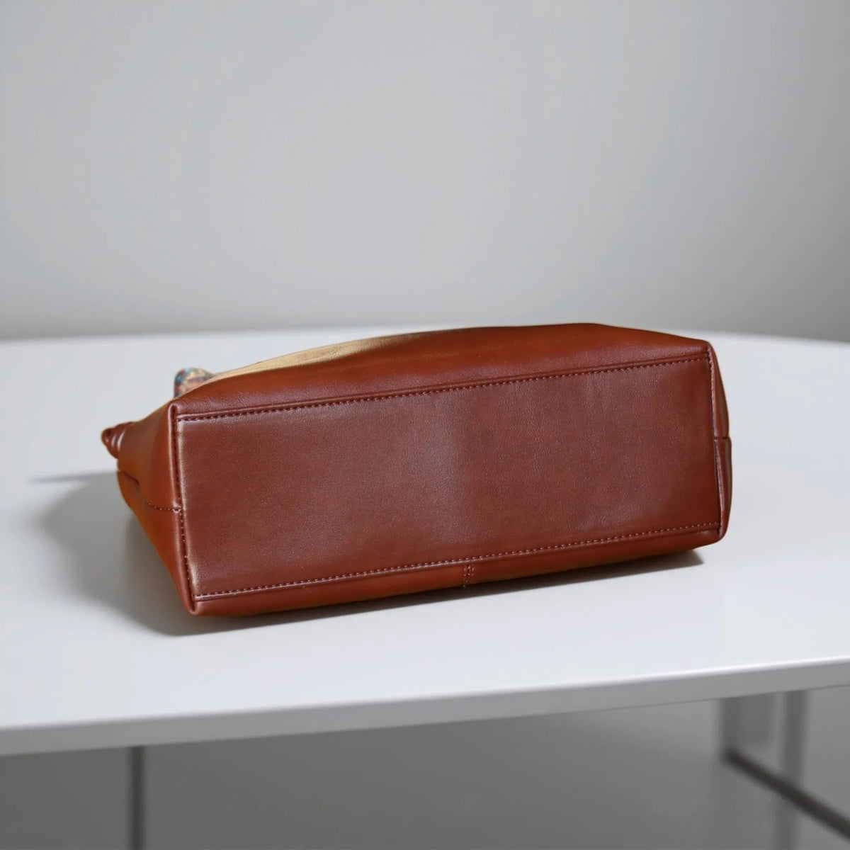 Genuine leather creative large capacity hand shoulder commuter bag in black, pillow shape, 31x11x24cm