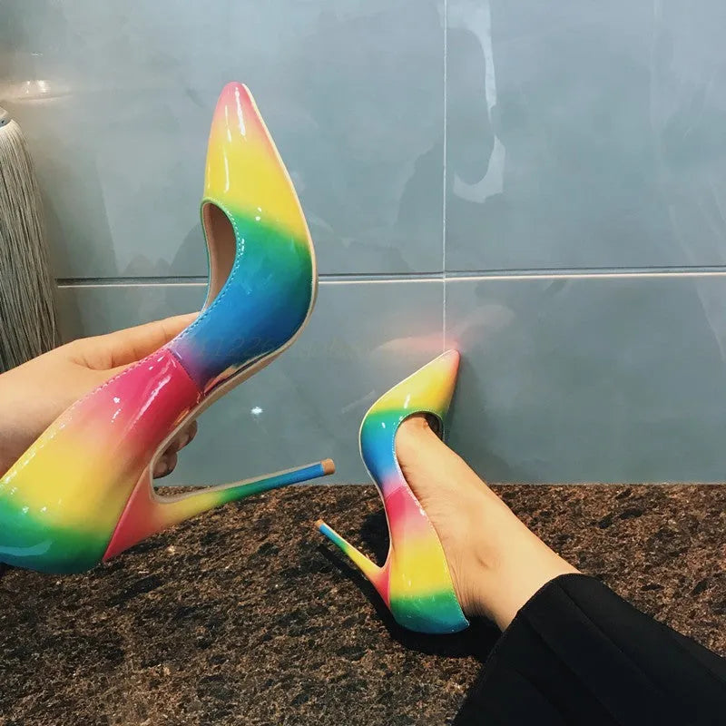 Rainbow patent leather women's ultra-high heel shoes with pointed toe and thin heel.