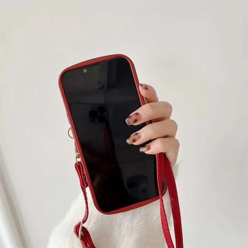 Red TPU crossbody card holder with lanyard for iPhone 15 showing diamond plaid pattern and rear card slot