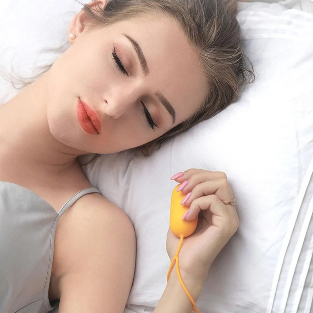 Handheld micro-current sleep aid device with round button and USB charging port
