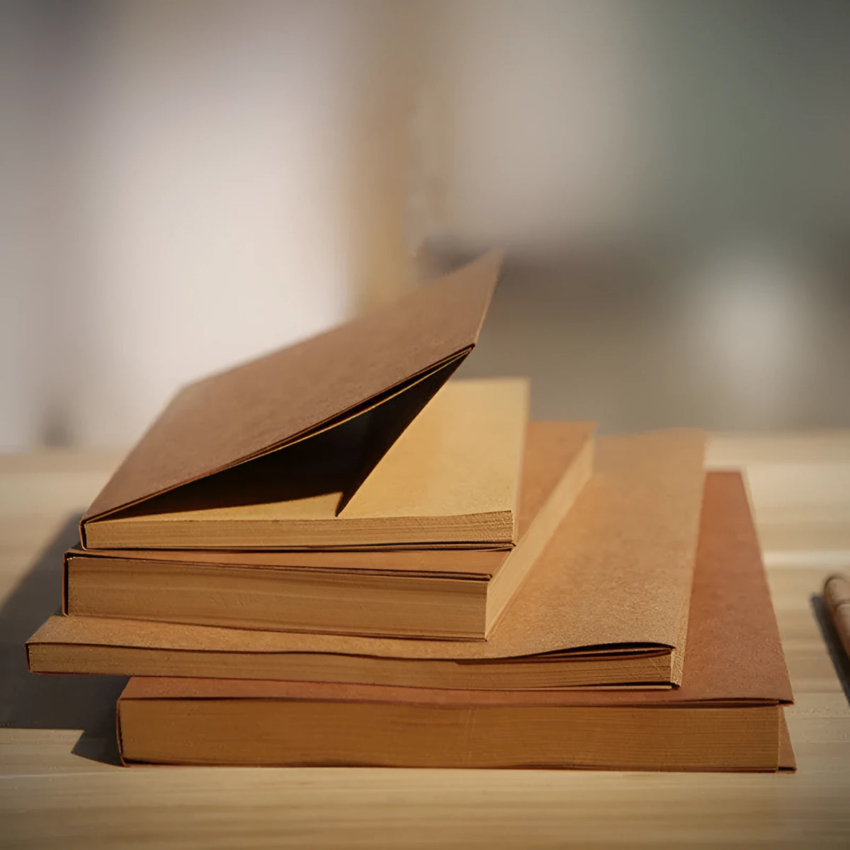 Brown kraft paper sketchbook open to show blank pages, showcasing wireless binding and 16K or 32K size.